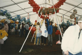 Group gathered under Filipino Pabitin in the Heritage Showcase tent