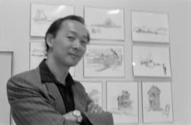 Artist Raymond Chow at a display of his drawings