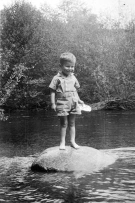 John Banfield standing on rock in stream