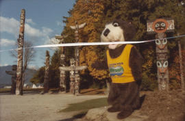 Tillicum in front of totem poles at Brockton Point