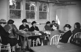 [Group of women knitting socks for the War effort]