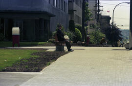 Strathcona/West End [Man on courtyard bench]