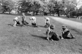 Girl Guides picking up litter from grassy area