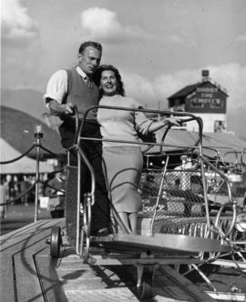 Couple on amusement park ride in P.N.E. Gayway