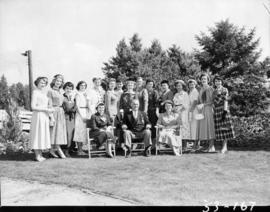 Group photograph of executive staff member F.J. Rundle with ladies