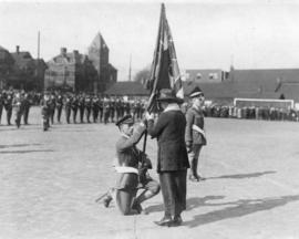 [Mrs. J.Z. Hall presents the King's Colour to Lieutenant McKay of the B.C. Regiment of The Duke o...