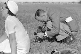 [Man adjusting a twin-lens reflex camera]