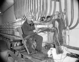 [B.C. Telephone technician wiring circuits for the new telephone system]