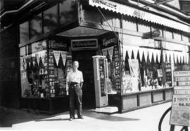 [Unidentified man standing in front of one of the Vancouver Drug Company stores]