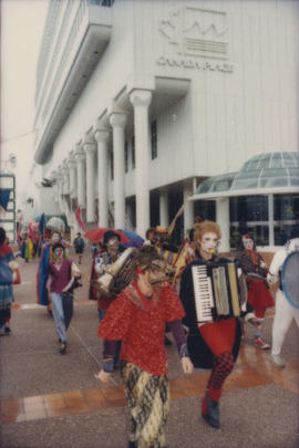 Group wearing costumes march in the Beaux Gestes parade