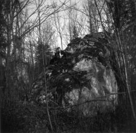 Big rock on McCleery farm. Ken McCleery and Betty McCleery [seated] on rock.