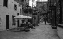 [Couple walking near Blood Alley] in Gastown