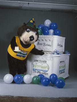 Tillicum standing beside large birthday cake