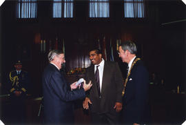 Mayor Philip Owen and Roméo LeBlanc present certificate to [Olympic] athlete in council chambers