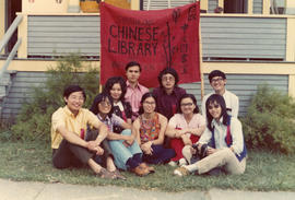Group of youth sitting with sign for the Strathcona Chinese Library and Information