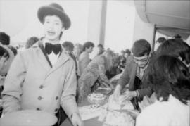 Man in clown costume serving cake