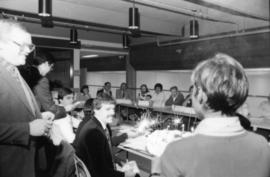 Group looking at birthday cake with sparklers