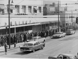 [People waiting in line outside of Jermaine's for sale]