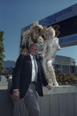 George Puil with Cats cast members in front of the Queen Elizabeth Theatre Bank of Montreal signb...