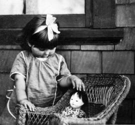 Cecily R. Hunt playing with doll