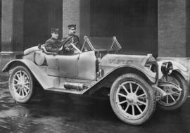[Deputy Chief C. Thompson and driver seated in Fire Department automobile]