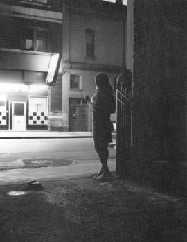 View of women standing in darkened street, suggestive of prostitution