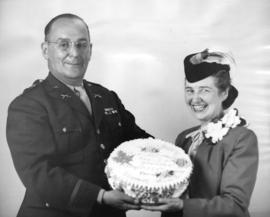 [Mrs. Margaret McNeil shows the birthday cake sent from Vancouver, B.C.]