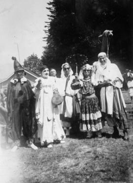 Picnic scene [people wearing pantomine costumes]