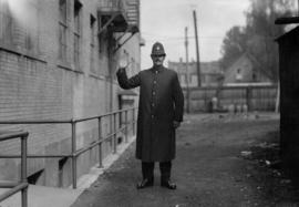 Police constable making hand signal "halt"