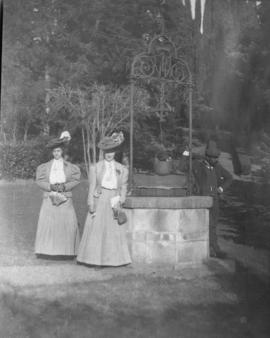 Aldyen Hendry with a woman and a man standing by a well