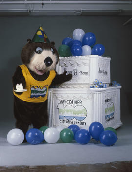 Tillicum standing beside large birthday cake