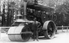 [Men standing in front of steam roller]