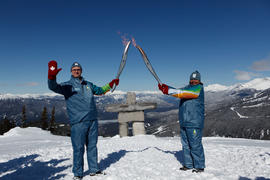 Torchbearers 7 and 8 pass the flame atop Whistler mountain
