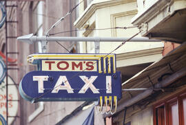 [Sign for Tom's Taxi at 111 East Pender Street]