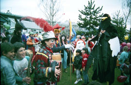 Crowd wearing costumes at Fool's Day Parade