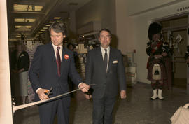 Gordon Campbell and unidentified man cutting ribbon at Legacies Program event at The Bay