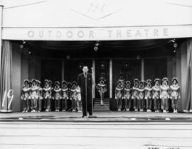 Female performance group and announcer on stage