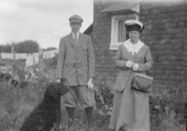 An unidentified woman with Robert Girvan and his dog