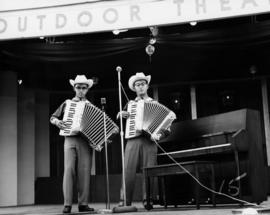 Performance of two youths playing accordions on stage