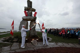 Day 106 Torchbearer 33 Judy Caldwell is passing the flame to torchbearer 34 Rolly Fox in front of...