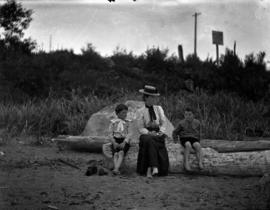 Woman and two children on the beach