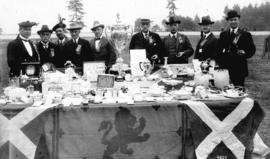 [Caledonian Games officials and prize table at Brockton Point]