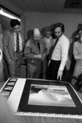 Toni Onley (centre) and group examine his Centennial Art Series print at Agency Press