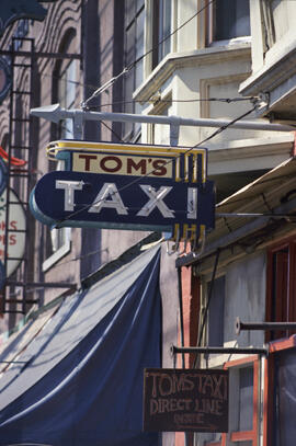 [Sign for Tom's Taxi at 111 East Pender Street]