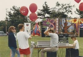 Sound technician in front of outdoor stage at Centennial event