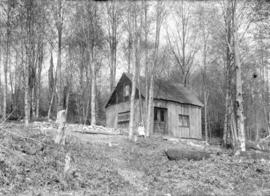 [Girl sitting in front of Kirkwood residence behind Chekwelp Reserve, Gibson's Landing]