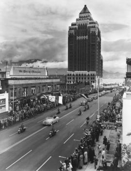 [View of H.R.H. Princess Elizabeth and the Duke of Edinburgh in motorcade proceeding south on Bur...