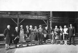 [Group portrait of Mayor L.D. Taylor with pageant contestants at C.P.R. Station]