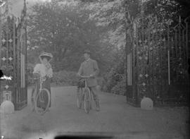 P.J. and Evelyn Salter with bicycles standing between a gate entrance