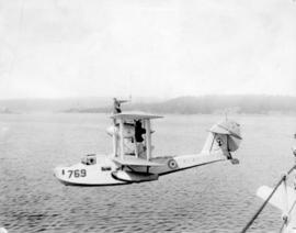 [A Supermarine built "Walrus" seaplane suspended from a crane]